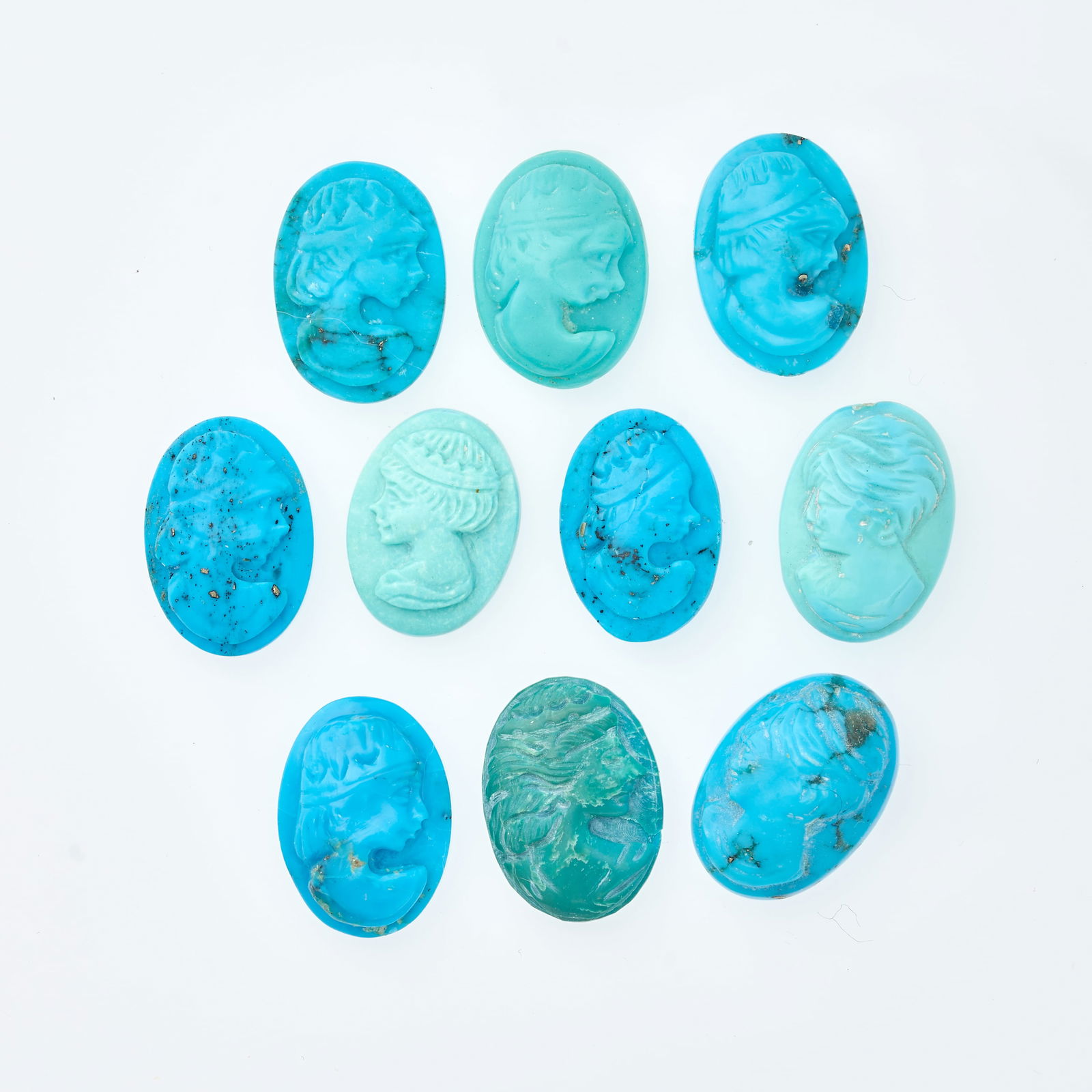 A COLLECTION OF UNMOUNTED TURQUOISE CAMEOS carved with the busts of female figures, all totalling (1 of 1)