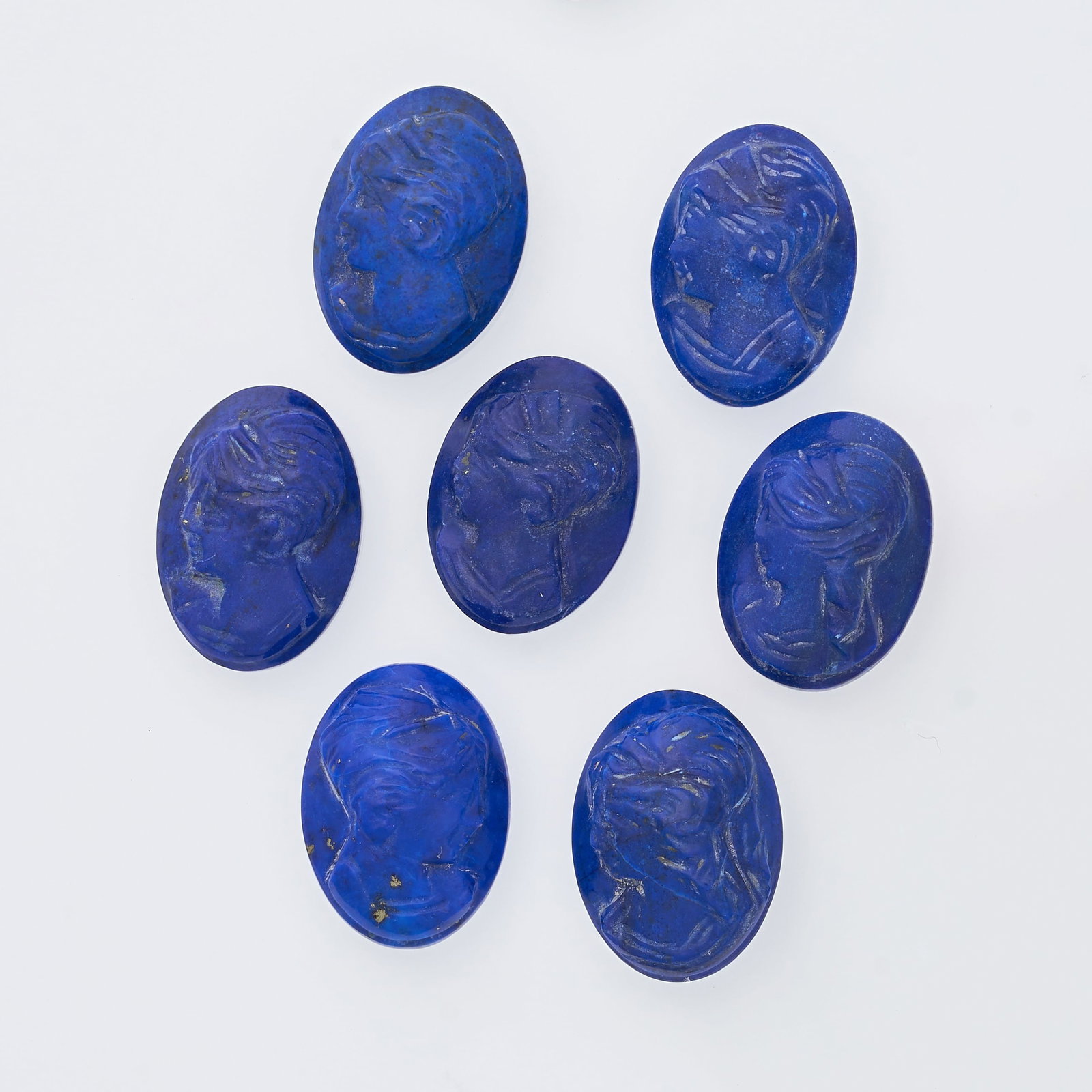 A COLLECTION OF UNMOUNTED LAPIS LAZULI CAMEOS carved with the bust of a female figure, all totalling: A COLLECTION OF UNMOUNTED LAPIS LAZULI CAMEOS carved with the bust of a female figure, all totalling 30.50 carats.