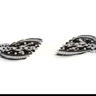 DREICER & CO., A FINE ANTIQUE BELLE EPOQUE ONYX AND DIAMOND BOW BROOCH designed as an openwork bow: DREICER & CO., A FINE ANTIQUE BELLE EPOQUE ONYX AND DIAMOND BOW BROOCH designed as an openwork bow set with old European and round cut diamonds, accented by rows of polished onyx, black satin set to t