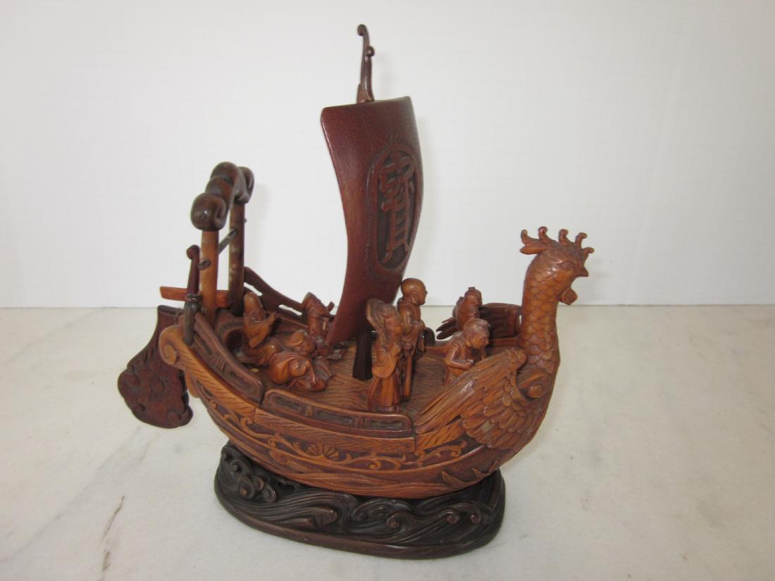 Japanese Boxwood Okimono: Japanese Boxwood Okimono of Takura Bune (Treasure Ship), with the 7 gods manning the ship. The rudder, sail, and gods are removable. Fine carved hardwood stand. Nice quality piece. 10"x4"x11".