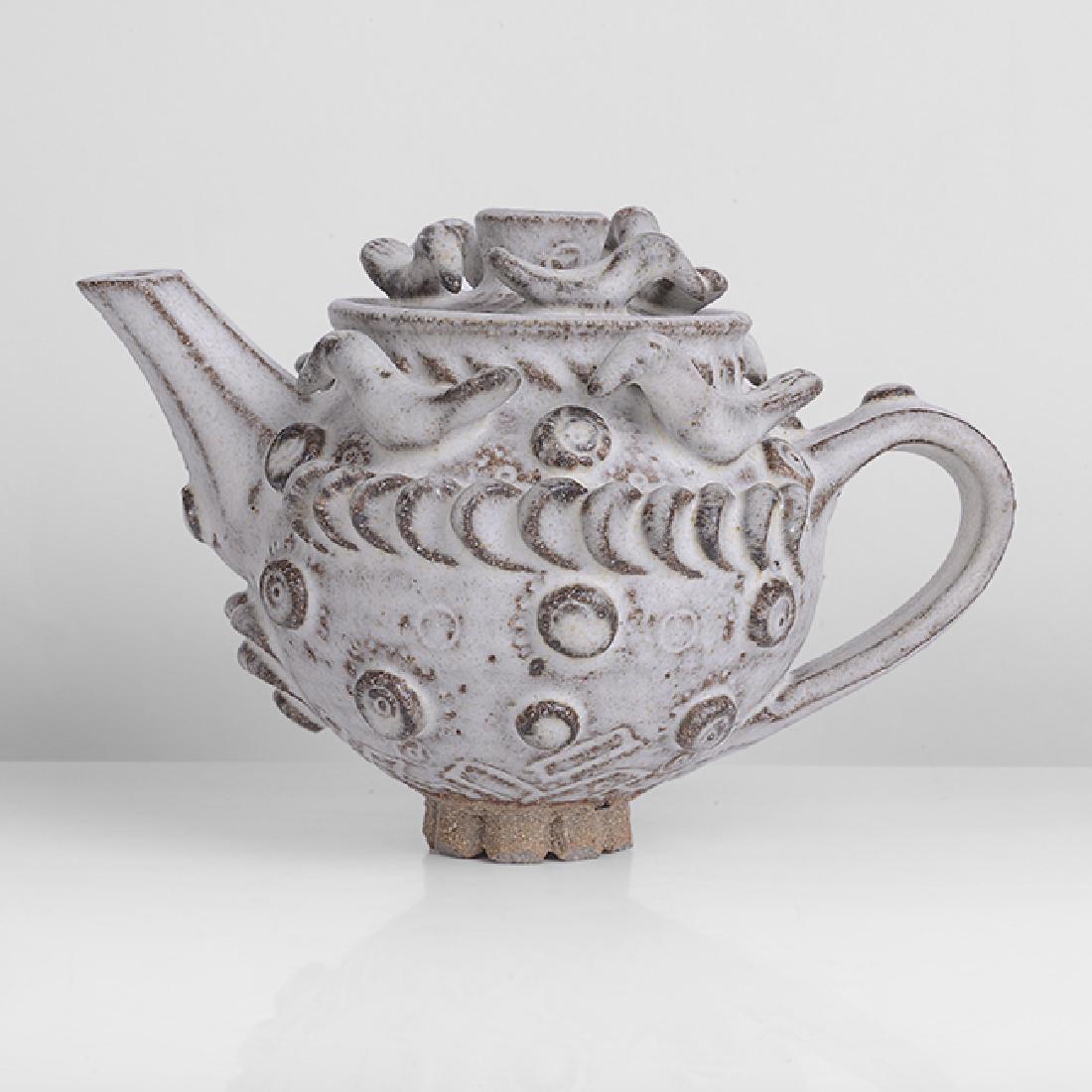 Ian Godfrey (British, 1942-1992): Small Teapot Stoneware, soft white glaze, thinning at the edges, four birds mounted to the shoulder and applied prunts around the body, another four birds mounted to cover, with faceted spout and smal