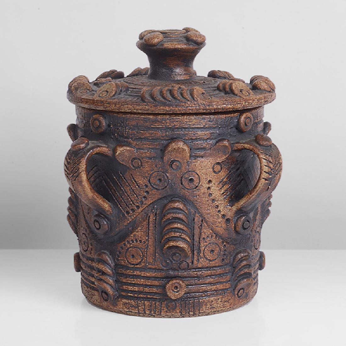 Ian Godfrey (British, 1942-1992): Tyg Style Jar and Cover Stoneware, dry dark brown glaze with manganese splashes, four looping handles below the rim, applied with raised dots and incised and impressed geometric designs around the bod