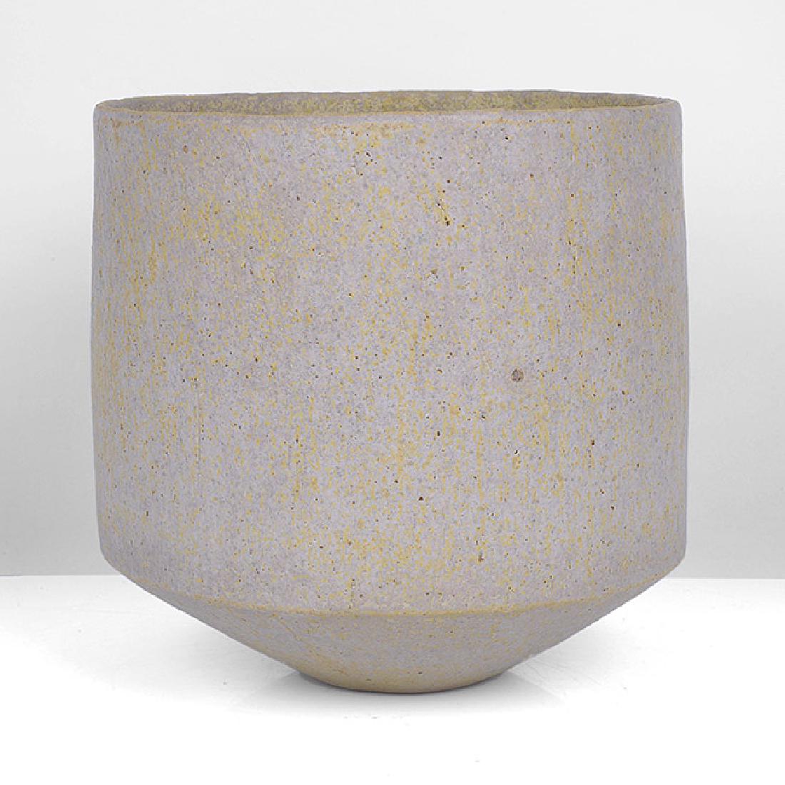 John Ward (British, b.1938): Early Vessel, circa 1985 Stoneware, soft mottled grey and yellow glaze over a textured surface, the cylindrical form rising from an angled base, impressed JW seal H 16.0cm, D 16.0cm PROVENANCE: The Pi