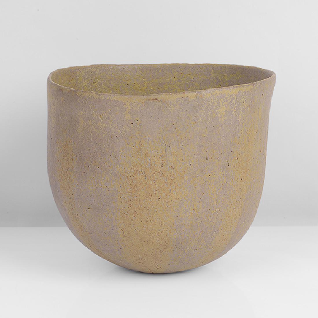 John Ward (British, b.1938): Asymmetric Pot, circa 1985 Stoneware, mottled pale brown and matt yellow glazes with subtle alternating bands around the body, the interior with mottled yellow glaze, the form with gently asymmetric t