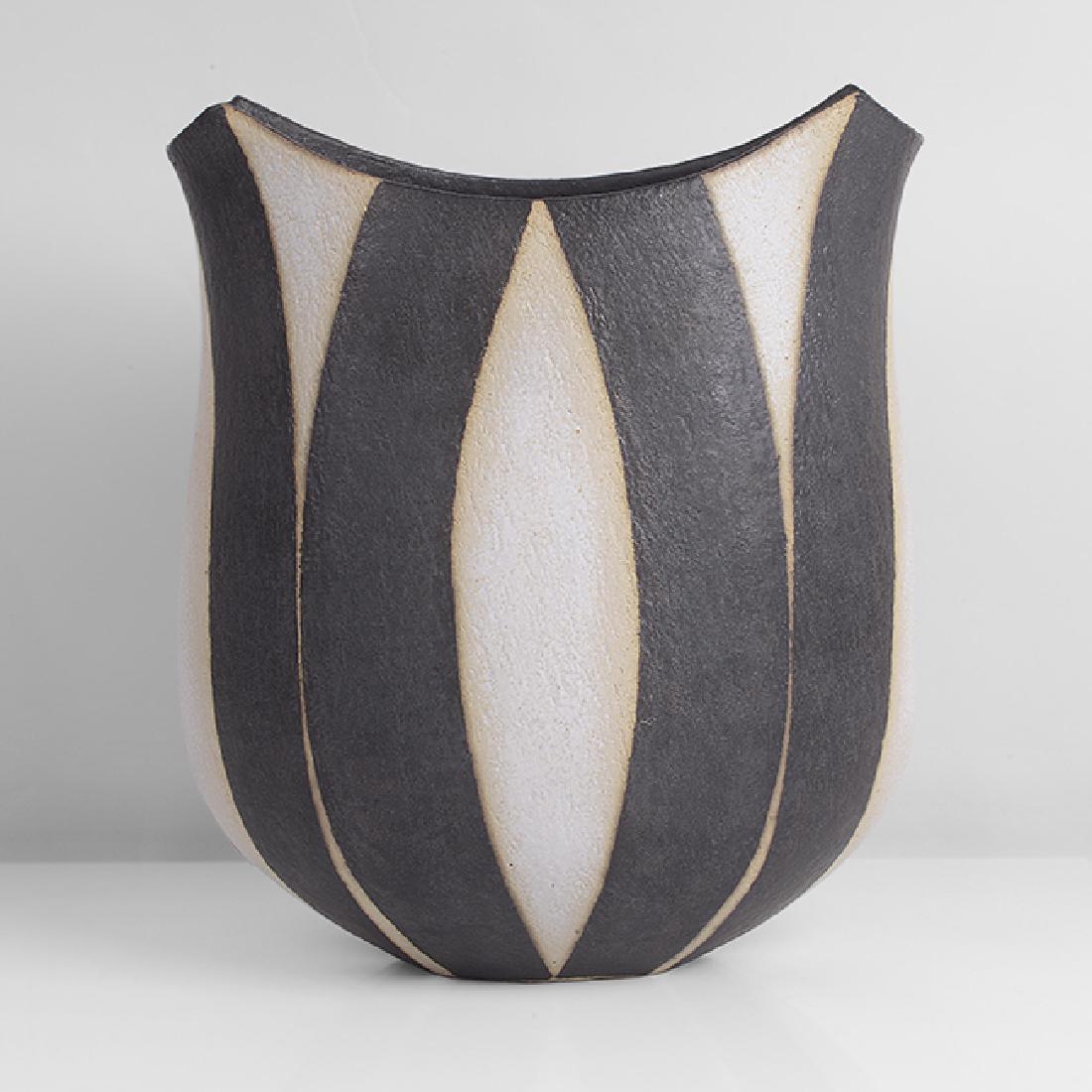 John Ward (British, b.1938): Double lipped Vessel, circa 1995 Stoneware, alternating matt black and white arcing bands over a lightly textured surface, the flattened form with extended rim on two sides, impressed JW seal H 26.5cm