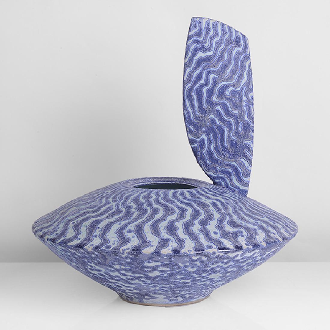 Peter Beard (British, b.1951): Vessel with Sail, circa 1995 Stoneware, undulating bands of mottled blue and white glazes, a tall 'sail' form mounted to the rim, impressed PFB and maker's marks H 26.3cm, D 26.3cm PROVENANCE: Private