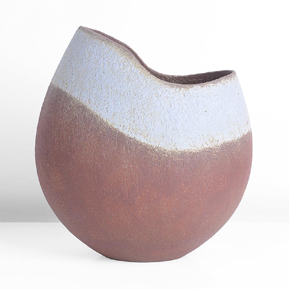 John Ward (British, 1938) Vessel with Cut Rim, circa: John Ward (British, 1938) Vessel with Cut Rim, circa 1995 Stoneware, dry red brown glaze with a broad pale blue band around the asymmetric cut rim, a sharp ridge running down the shoulder from the hig