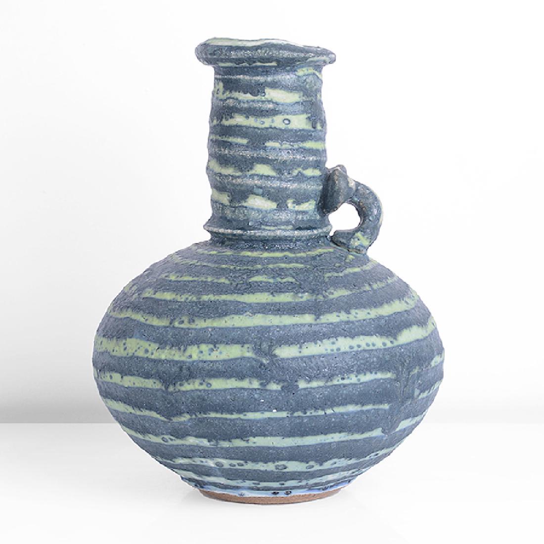 Peter Beard (British, b.1951) Flask Form, circa 1980: Peter Beard (British, b.1951) Flask Form, circa 1980 Stoneware, flask form with horizontal bands of dark and light green glaze, small loop handle, impressed PFB and seal H 19.6cm, D 14.6cm PROVENANCE: