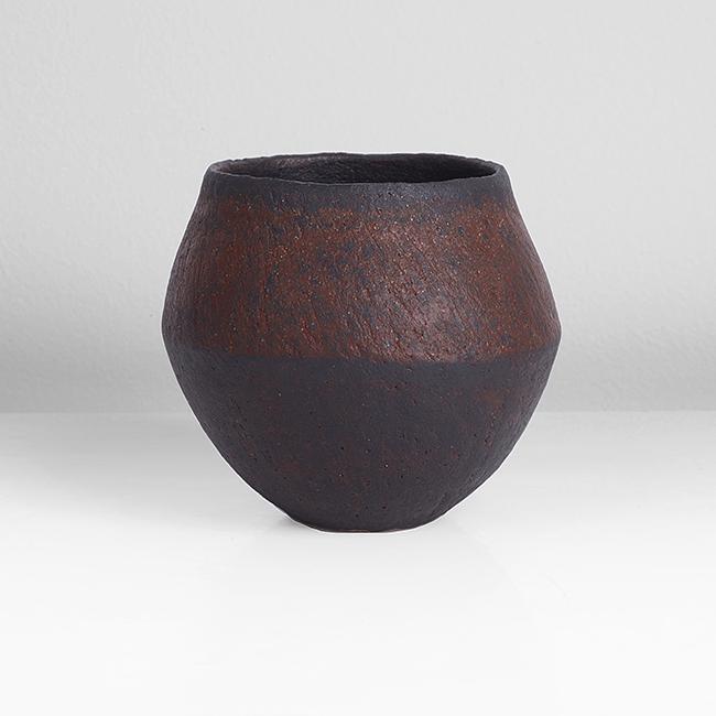 John Ward (British, b.1938) Small Pot, circa 1995: Stoneware, mottled dark brown and rich red glazes over a textured surface, impressed JW seal Dimensions: H 7.4cm, D 8.1cm To place a bid in this auction, please go to www.maaklondon.com