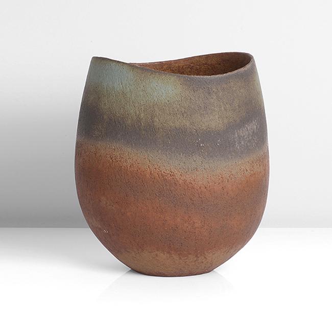 John Ward (British, b.1938): Oval Vessel with Dipped Rim, circa 1988 Stoneware, mottled undulating bands in deep rust orange, brown, turquoise and dark grey glazes, the interior with mottled deep rust orange and brown glazes, imp