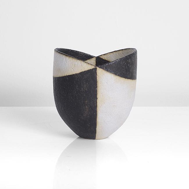 John Ward (British, b.1938): Small Pot with Cut Rim, circa 1995 Stoneware, matt black and white glazes in alternating bands accentuating the lines of the V cut rim, soft cream bleed where contrasting colours meet, impressed JW se