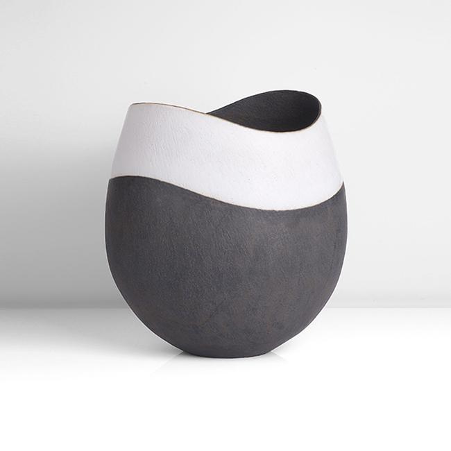 John Ward (British, b.1938): Monumental Vessel with Dipped Rim, circa 2003 Stoneware, matt black glazed body with a wide matt white glazed band following the undulating contours of the rim, interior in matt black, impressed JW se