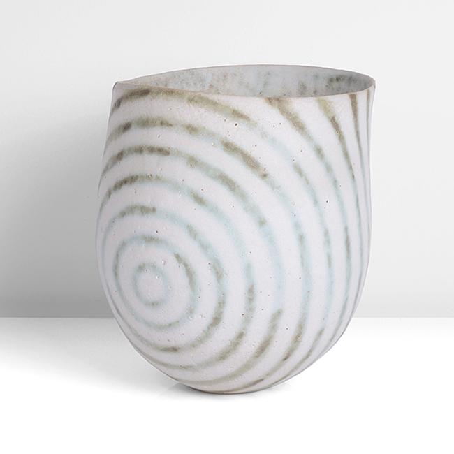 John Ward (British, b.1938): Asymmetric Vessel, circa 1995 Stoneware, radiating circular design in alternating green and white glazes with a soft speckle, the interior in mottled white, green and grown glazes, impressed JW seal S