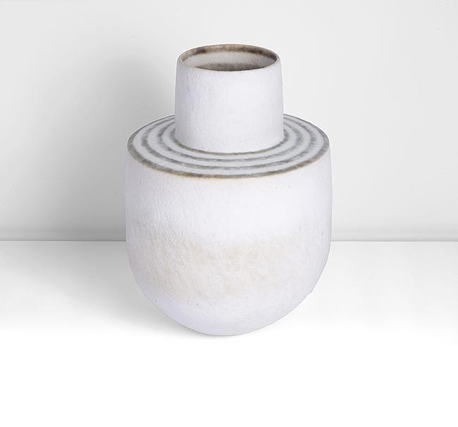 John Ward (British, b.1938): Vessel with Cylindrical Neck, 2004 Stoneware, white glaze over a soft diagonally textured surface with pale green mottles, the flattened shoulder with concentric mottled green bands and green rings to