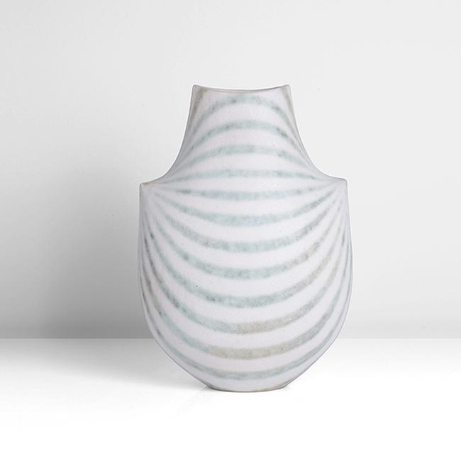 John Ward (British, b.1938): Shouldered Vessel, circa 1995 Stoneware, matt white softly pitted glaze with arching green mottled bands radiating from the two pointed shoulders, a single deep green spot to one face, rising to a tap