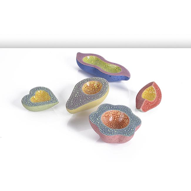 Kate Malone (British, b.1959): Five 'Baby Sliced Fruits', circa 1995 Earthenware, vivid multicoloured crackle glazes to the upper section with a matt flecked glaze to the underside Size Peapod H 3.2cm, W 17.0cm, D 6.5cm Notes PROVE