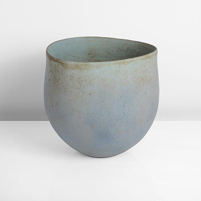 John Ward (British, b. 1938): Asymmetric Vessel, 1992 Stoneware, mottled turquoise blue and green glazes with brown speckles, the rounded form squeezed to a soft undulating oval at the rim, impressed J