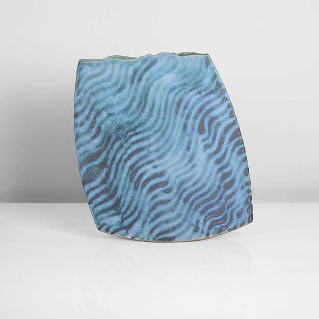 Peter Beard (British, b.1951): Rocking Vessel', circa 1995 Stoneware, undulating diagonal bands of mottled turquoise and blue glazes over a dark grey ground, the flattened leaning form with irregular rim and set on a curved base, i