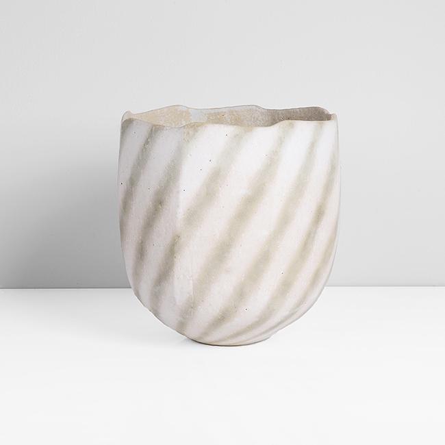 John Ward (British, b.1938): Faceted Bowl Stoneware, matt white glaze with mottled green diagonal linear design, mottled white and green interior, cut sided body with undulating rim, impressed JW seal H 17cm, 16.6cm PROVENANCE: T