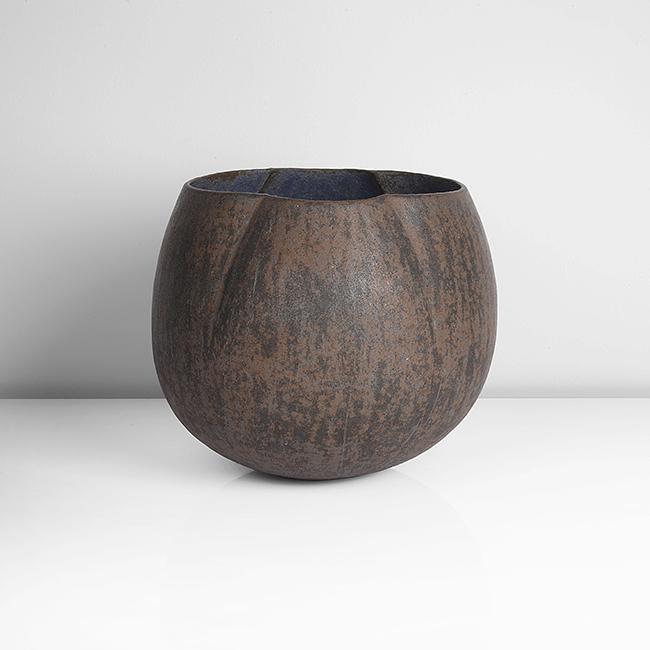 John Ward (British, b.1938): Lobed Vessel, circa 1990 Stoneware, mottled dark and paler brown glazes with blue mottled interior, impressed JW seal H 22.0cm, D 25.1cm PROVENANCE: Private Collection, Somerset CONDITION: Perfect con