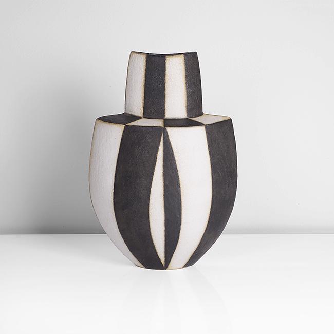 John Ward (British, b.1938): Shouldered Vessel, circa 1995 Stoneware, matt black and white alternating bands over a textured surface, the flattened form with angled elliptical shoulder and tall tapering neck, impressed JW seal H