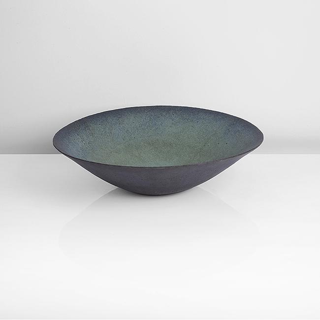 John Ward (British, b. 1938): Open Bowl, circa 1990 Stoneware, mottled blue, turquoise and green glazes to the well, the exterior in mottled brown and blue glazes, impressed JW seal DIMENSIONS: H 10.1cm, D 37.3cm PROVENANCE: The C