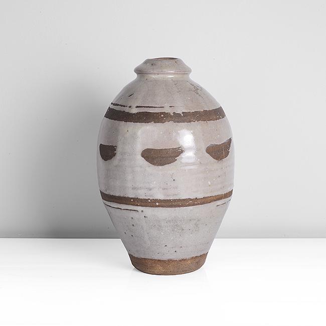 Bernard Leach (British, 1887-1979): Vase, circa 1926 Stoneware, grey crackle glaze with band of wax resist decoration, impressed BL and Leach Pottery seals Dimensions: H 26.4cm, D 17.4cm PROVENANCE: Dr John P Driscoll Collection Bonhams