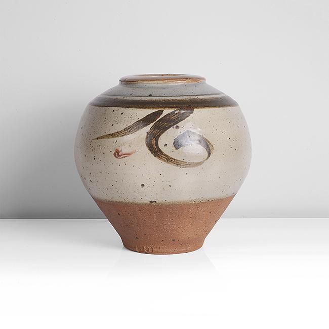 Bernard Leach (British, 1887-1979): Vase, circa 1960 Stoneware, cream glaze with strong iron speckle, blue and iron bands at the shoulder and orange to the flat rim, three iron painted and combed abstract designs around the body, the lo