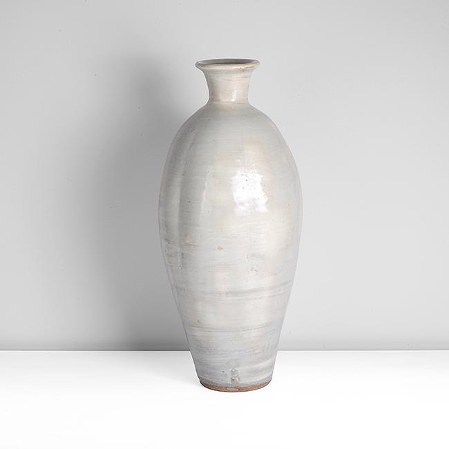 Bernard Leach (British, 1887-1979): Bottle Vase, circa 1960 Stoneware, pale blue celadon glaze over white brushed slip, the body divided into six sections by impressed vertical lines, impressed BL and Leach Pottery seals partially obscu