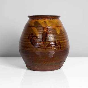 Bernard Leach (British, 1887-1979): Earthenware, cream slip beneath a dark amber glaze with iron painted foliate design front and back, impressed BL and Leach Pottery seals "All bidding must be placed through the Maak Contemporary Ceram