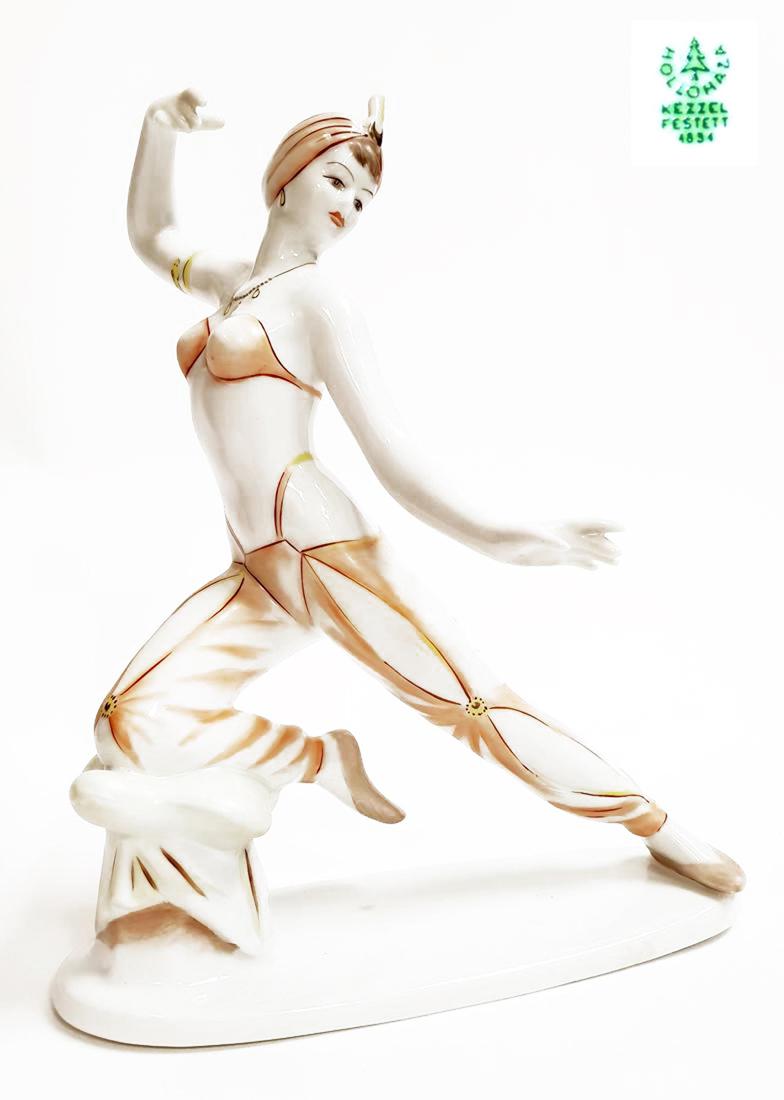 Vintage Orientalist Dancer Hollohaza Porcelain Figurine: A Vintage oriental Belly dancer Sheherezade circa 1960's Hollohaza Hand-painted Porcelain Sculpture. Stamped Hungarian Hollohaza "kezzel festett" (means hand-painted). Dimensions: 10" x 7.1/2" x 6"