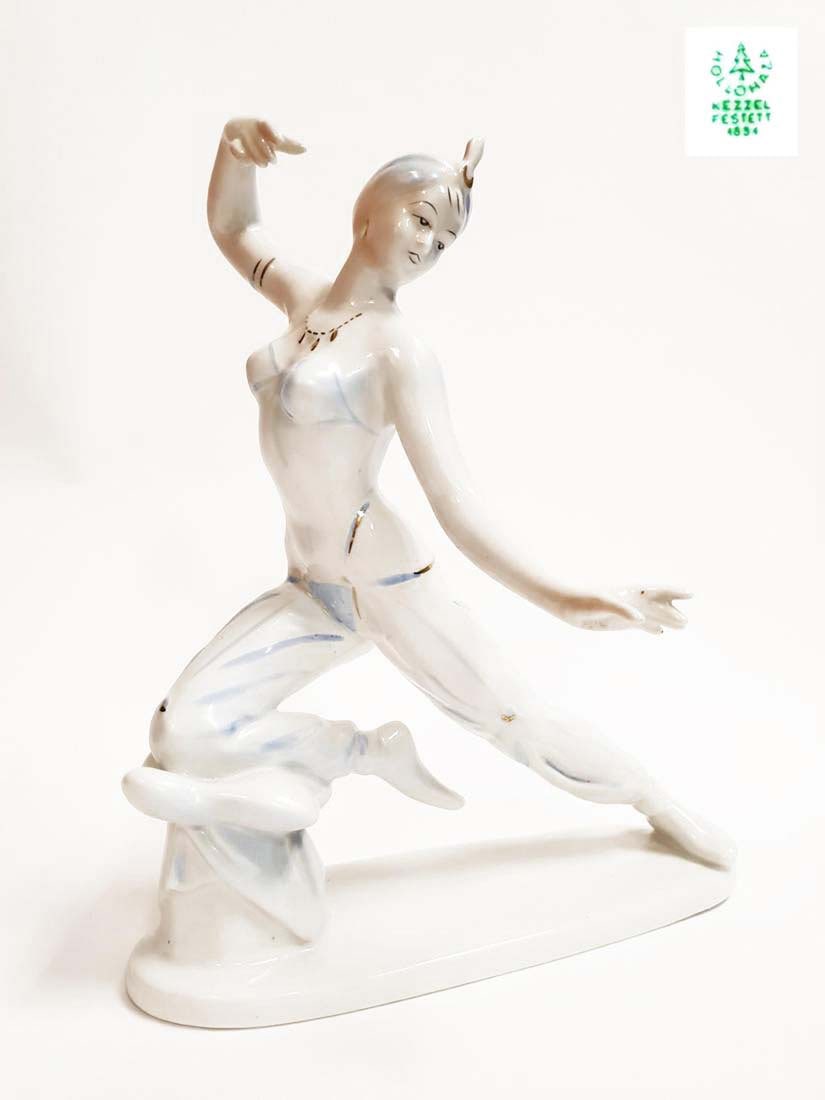 Vintage Orientalist Dancer Hollohaza Porcelain Figurine: A Vintage oriental Belly dancer Sheherezade circa 1960's Hollohaza Hand-painted Porcelain Sculpture. Stamped Hungarian Hollohaza "kezzel festett" (means hand-painted). Dimensions: 10" x 7.1/2" x 6"