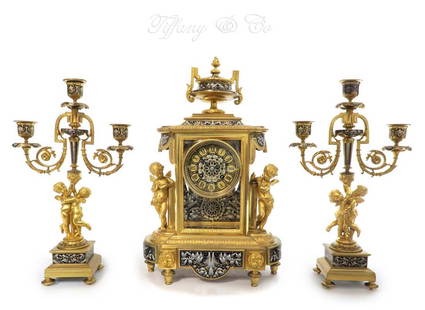 19th C Tiffany & Co Figural French Champleve Clock set: 19th C Tiffany & Co Figural French Champleve Clock set. Clock: H 16.1/4" x 10.1/4" x 6", Candelabras: H 14" x 8.1/2" x 3.1/2"