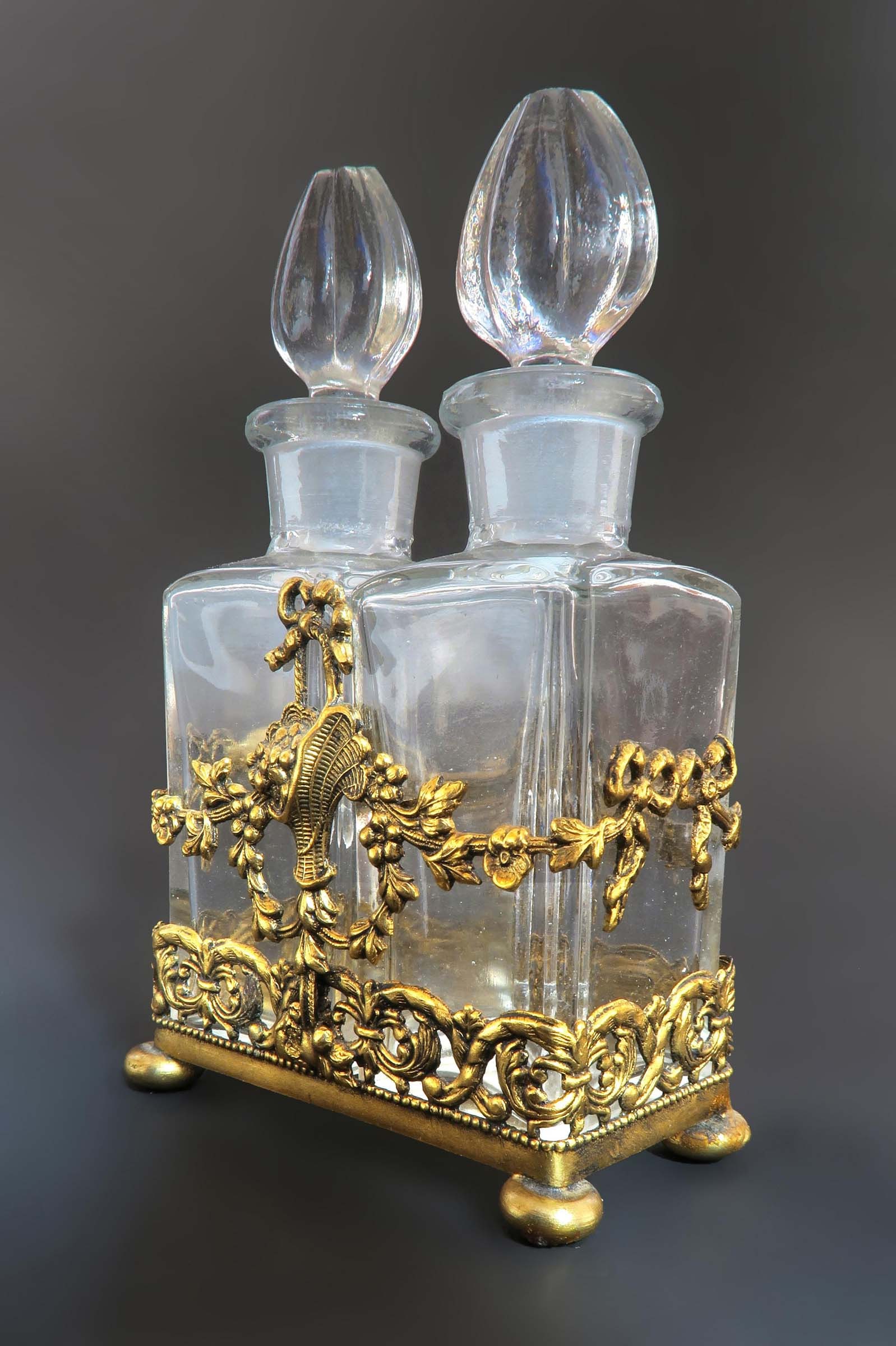 Apollo Studios Bronze & Crystal Perfume Bottles: A Baccarat Style Apollo Studios Ormolu & Crystal Perfume Bottles. Circa 1920's.