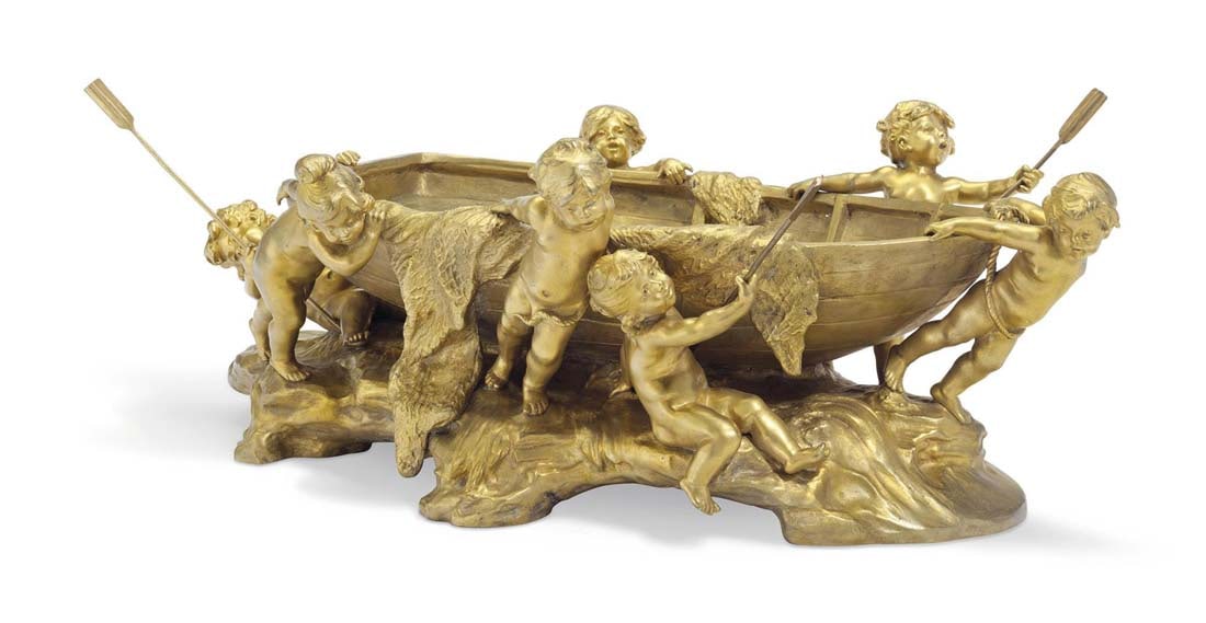 A FINE FRENCH ORMOLU FIGURAL CENTERPIECE: A FRENCH ORMOLU FIGURAL CENTERPIECE, CAST FROM A MODEL BY AUGUSTE MOREAU (1834-1917), CIRCA 1900. Modeled as six putti pulling a boat, the base inscribed Aug.t Moreau and numbered 1951. 8.1/4" (21