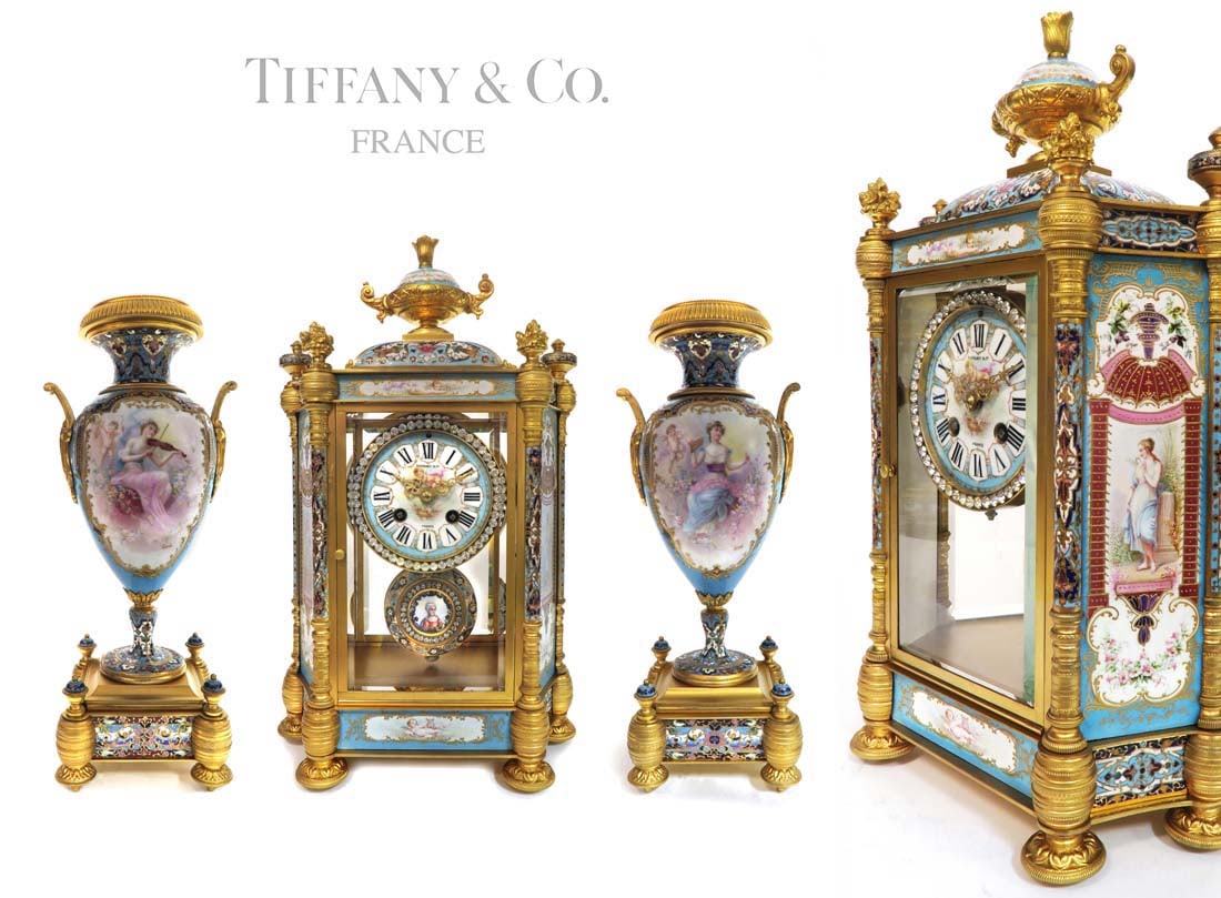 19th C. TIFFANY & Co. Sevres Champleve Enamel Clock Set: 19th C. French TIFFANY & Co. Sevres Porcelain And Champleve Enamel Clock Set. Clock: H 16" x 10" x 5.1/2", Urns: H 14" x 5" x 5"