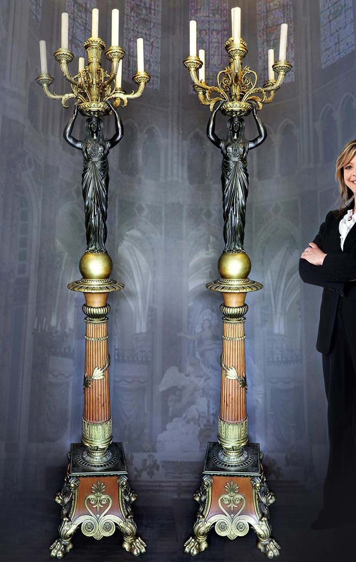 A monumental Pair of Empire Figural Torchiere. Circa 1820: A Monumental very fine pair of 1st Period French Empire Figural Torchiere in patinated and gilt bronze with two neoclassical Egyptian figures each holding 8 light candelabras after designs by Napoleon