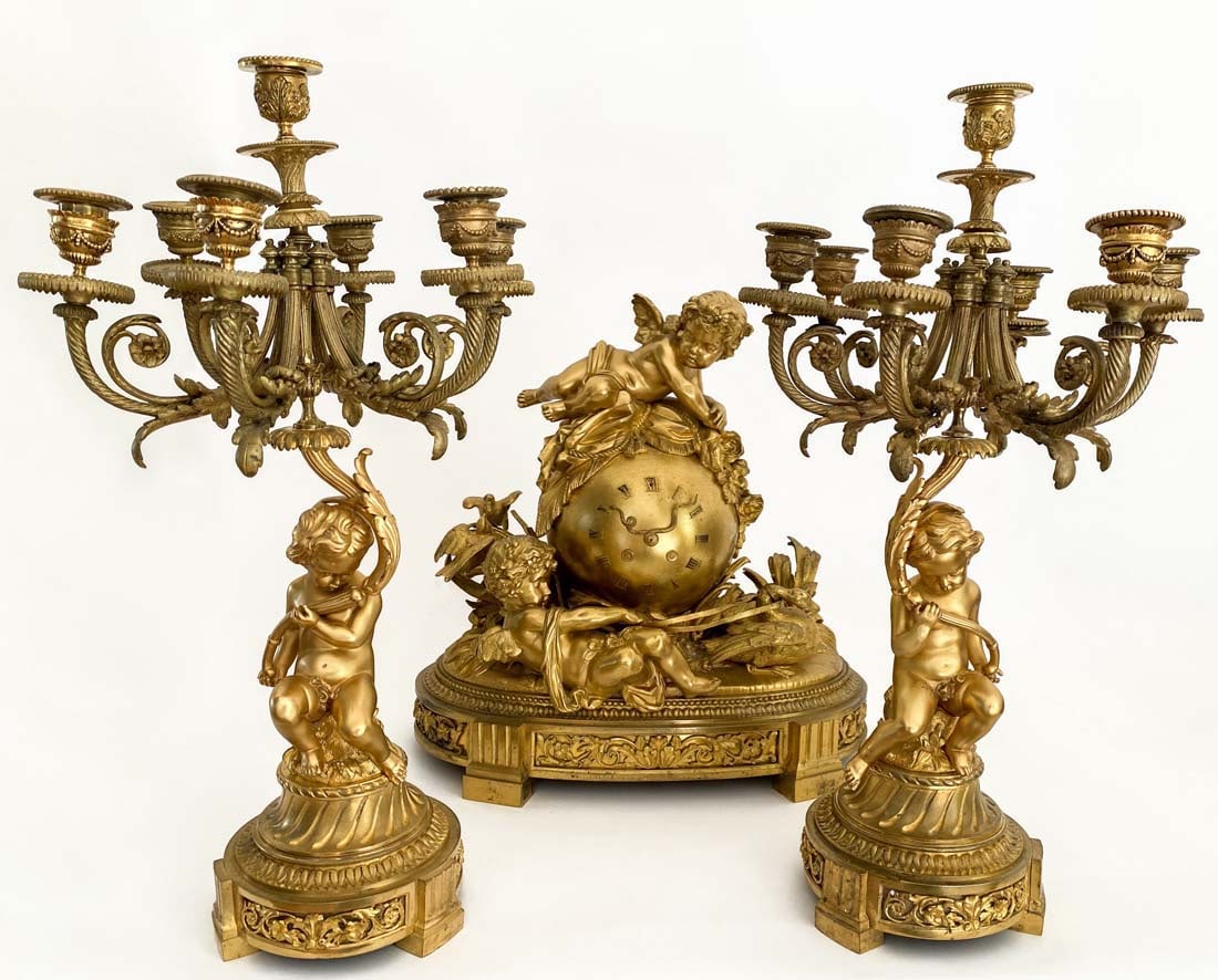 19th Century French Bronze Mantel Figural Clock set: 19th Century French Bronze Mantel Figural Clock set with Cupid Candelabras. Clock: H 17" x W 17" x D 9", Candelabras: H 21" x W 12" x D 12"
