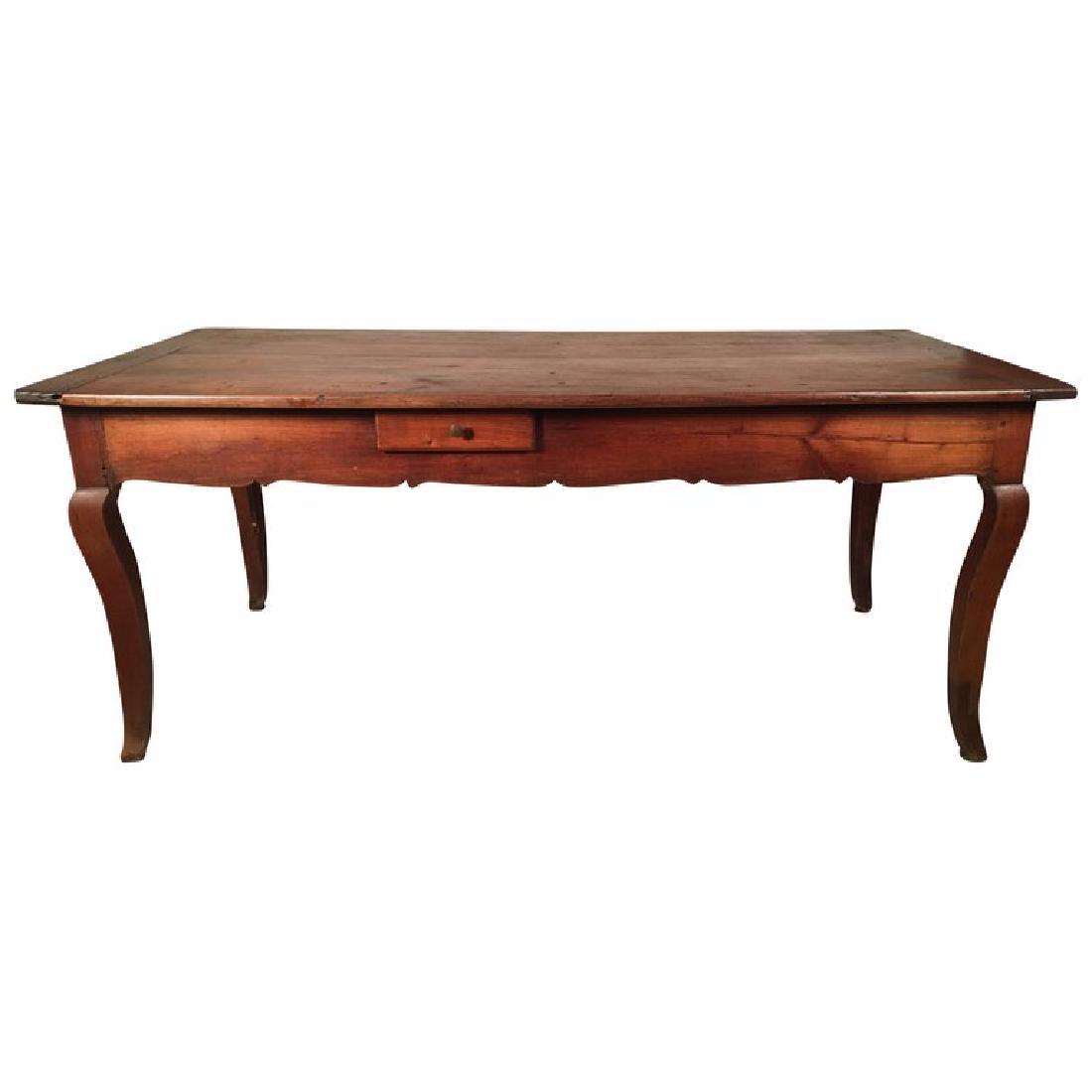 18th C. French Farm Table, Louis XV: A French Louis XV farm table in cherrywood with a scaloped apron,a large drawer on one end and a small drawer on one side, on cabriole legs, circa 1780. 73" w x 32" d x 30" h.
