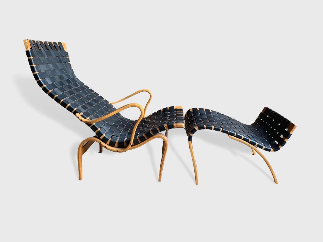 Bruno Mathsson Lounge Chair And Ottoman: A rare "Pernilla" lounge chair and ottoman signed Bruno Mathsson, Sweden, circa 1970, in bent plywood with black leather webbing. Dimensions: 66" l x 21" d x 36" h. Condition: Excellent