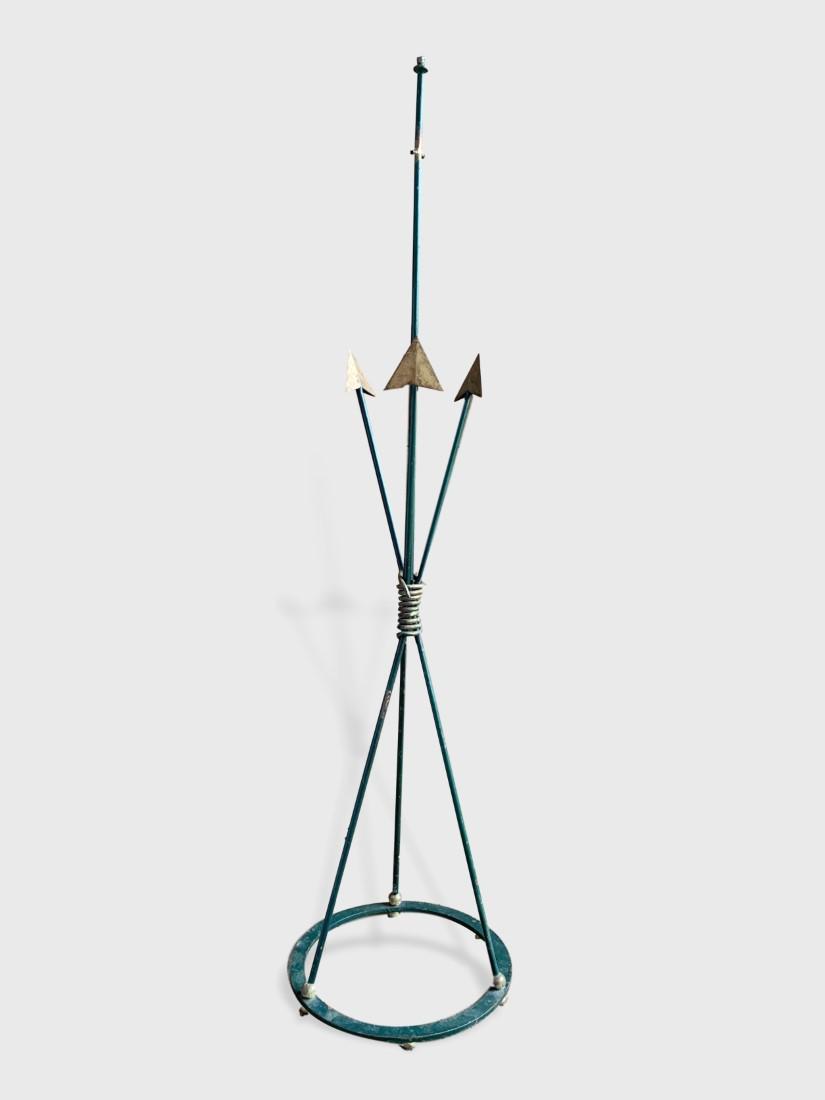 Royere Style Floor Lamp: A French 1940's wrought iron floor lamp in the style of Jean Royere, in the form of 3 arrows bound in the center, in old green paint and gilt details. Dimensions: 15" dia. X 63" h. Unelectrified.