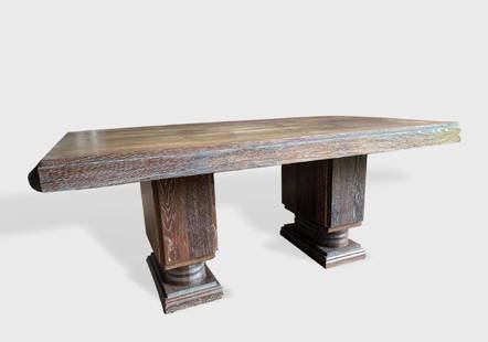 French 1940's Cerused Oak Dining Table: A dark cerused oak double-pedestal dining table with extension ends (lacking leaves) in the style of Charles Dudouyt, circa 1940. Dimensions: 74" l x 39" w x 30" h. Needs refinishing, but otherwise in