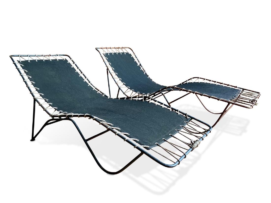 Pair Of Pipsan Saarinen Swanson Lounge Chairs: A pair of Pipsan Saarinen Swanson lounge chairs, in wrought steel and canvas, circa 1950. Dimensions: 61" l x 26" w x 30" h. Rust and pitting to frames.