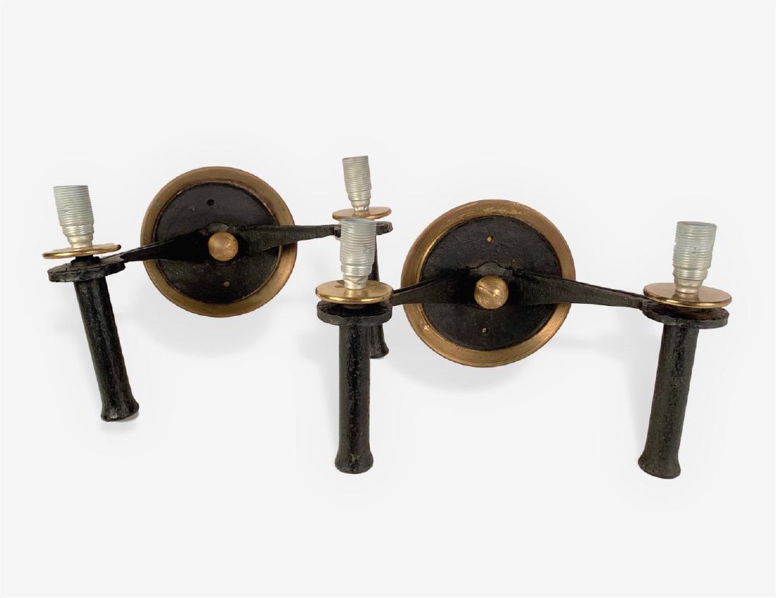 Pair Of Adnet Style Wall Sconces: A pair of wrought iron and brass 2-arm wall sconces, French 1950's, style of Adnet and Poillerat. Dimensions: 13" w x 9" h x 7" d. French wiring.