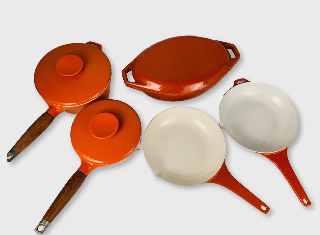 Set Of Orange Enamel Cookware: Set of COPCO cookware in cast iron and orange enamel, 1960's, including 2 fry pans, 1 cassarole with lid, 1 lg. saucepan with lid, 1 sm. saucepan with lid.Largest 13"