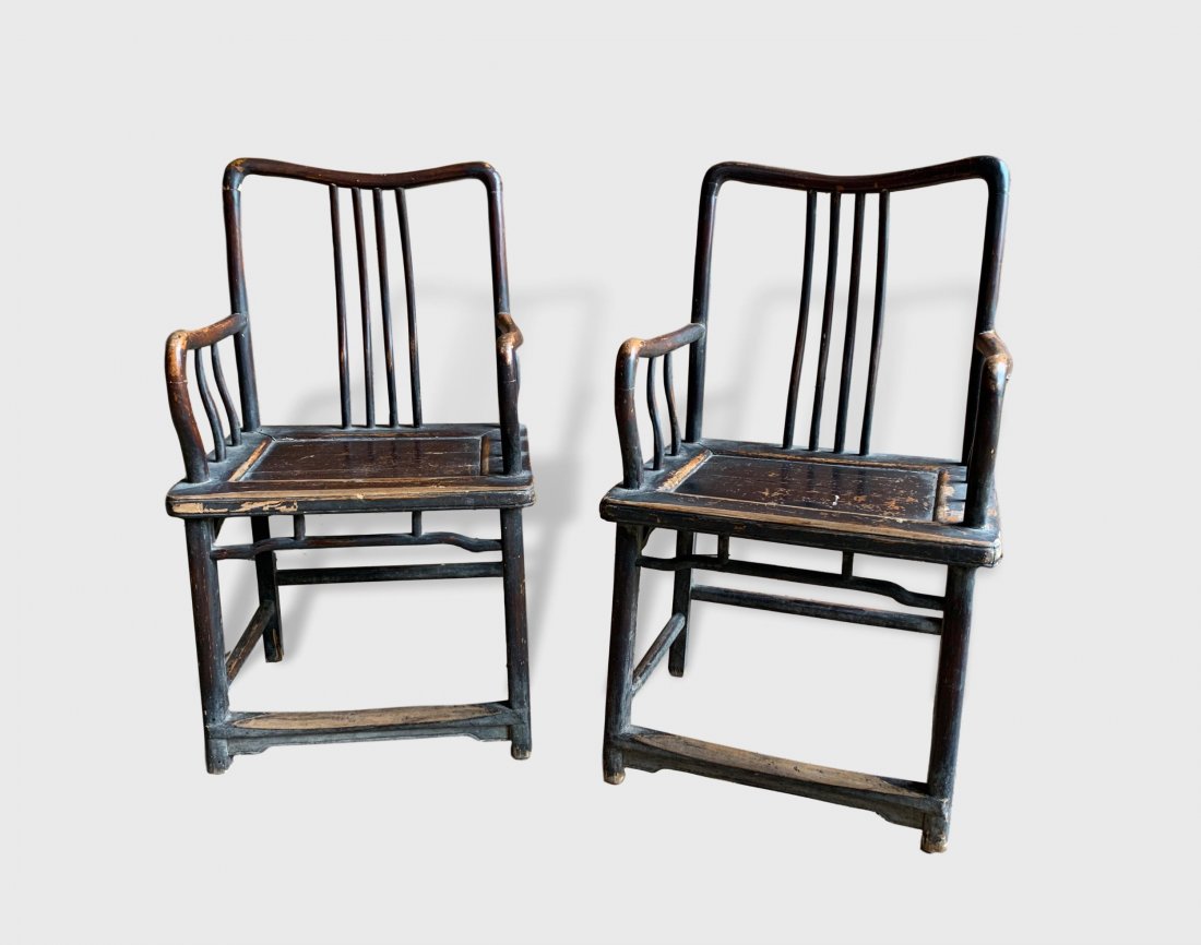 Pair Of Chinese Armchairs, 19th Century: A pair of fine 19th century Chinese Southern Administrator's armchairs in elm with gently curved crestrails and arms, four spindle backsplats, retaining much of their original brown lacquer finish. Di