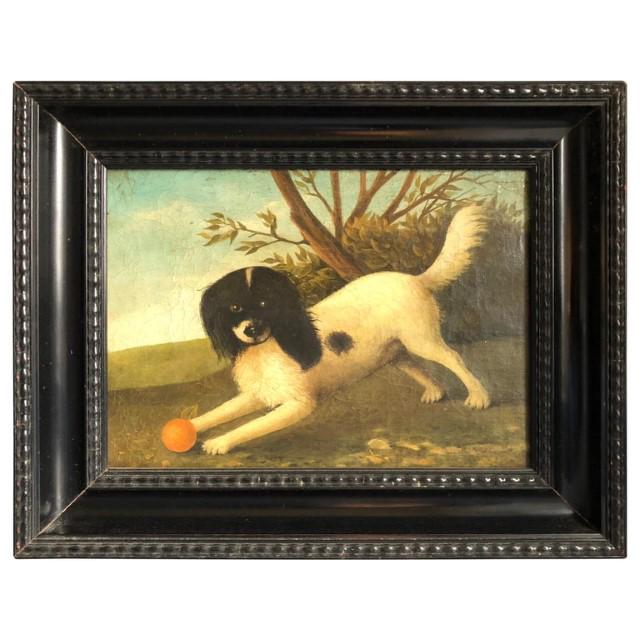 Dog Painting, French: A charming portrait of a dog playing with a ball, 20th century French, in a carved and ebonized wood frame. 17" w x 13.5" h