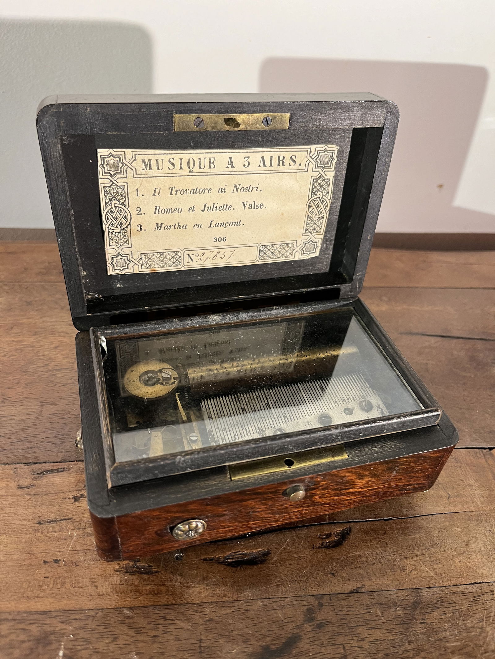 Small Music Box in Rosewood: A small music box in rosewood, 19th century French, with inlaid silver crest on lid. Working condition.5" w x 3.5" d x 2" h