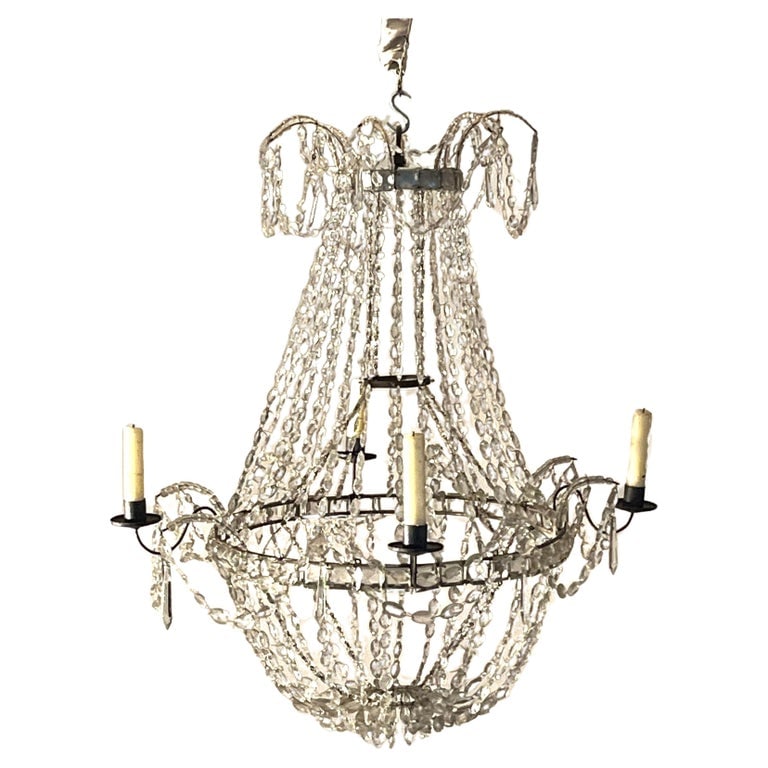 French Crystal Chandelier de Fete: A late 18th century French chandelier de fete in hand-cut graduating crystals, wire frame and 4 candle arms in tole. These were used as temporary lighting for events and parties and can be stored flat