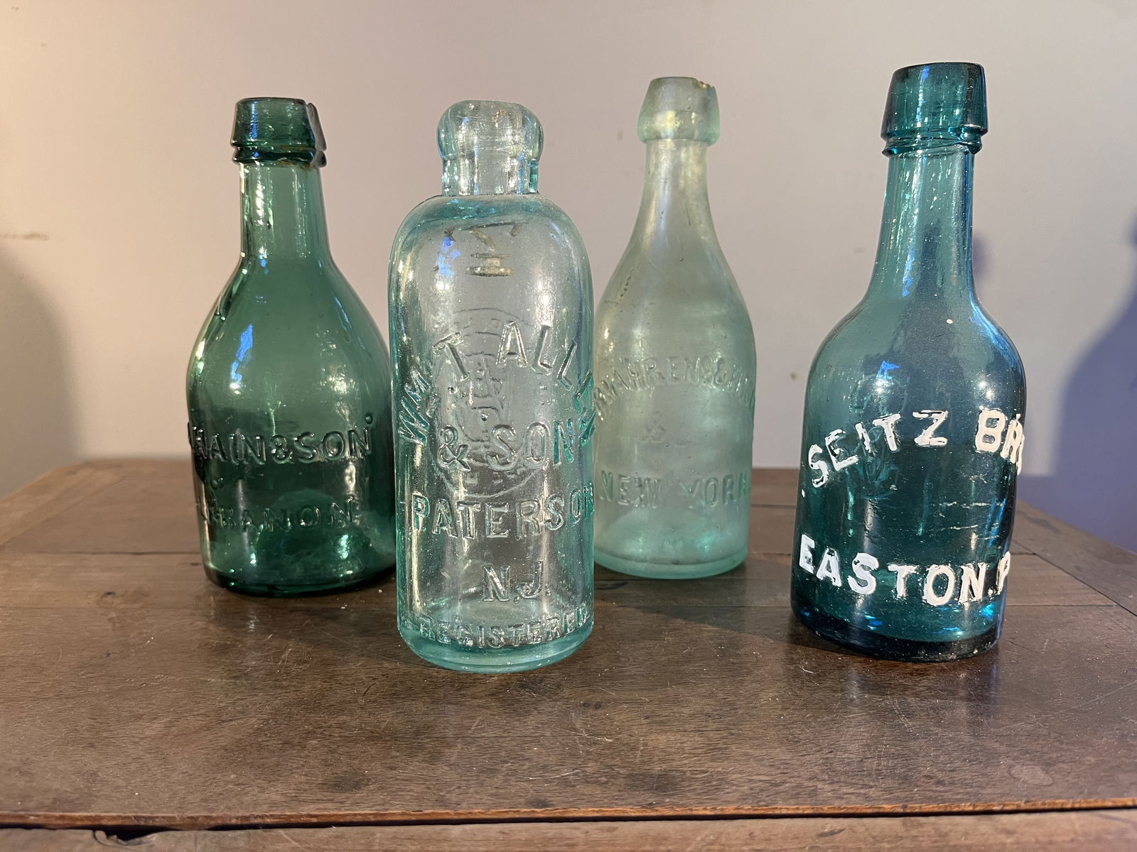 3 Squat Sodas and 1 Hutchinson Soda: 3 squat soda bottles, including A Hain & Sons, Seitz Bros., and Kornahrens & Fitschen, as well as a Wm T Allen Hutchinson soda.2.75 Dia. x 7" h